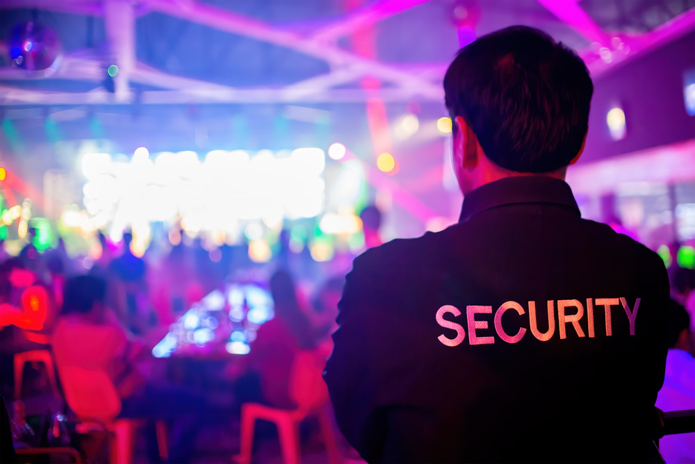 Security guard  are regulating the situation of safety in an event concert in a nightclub.